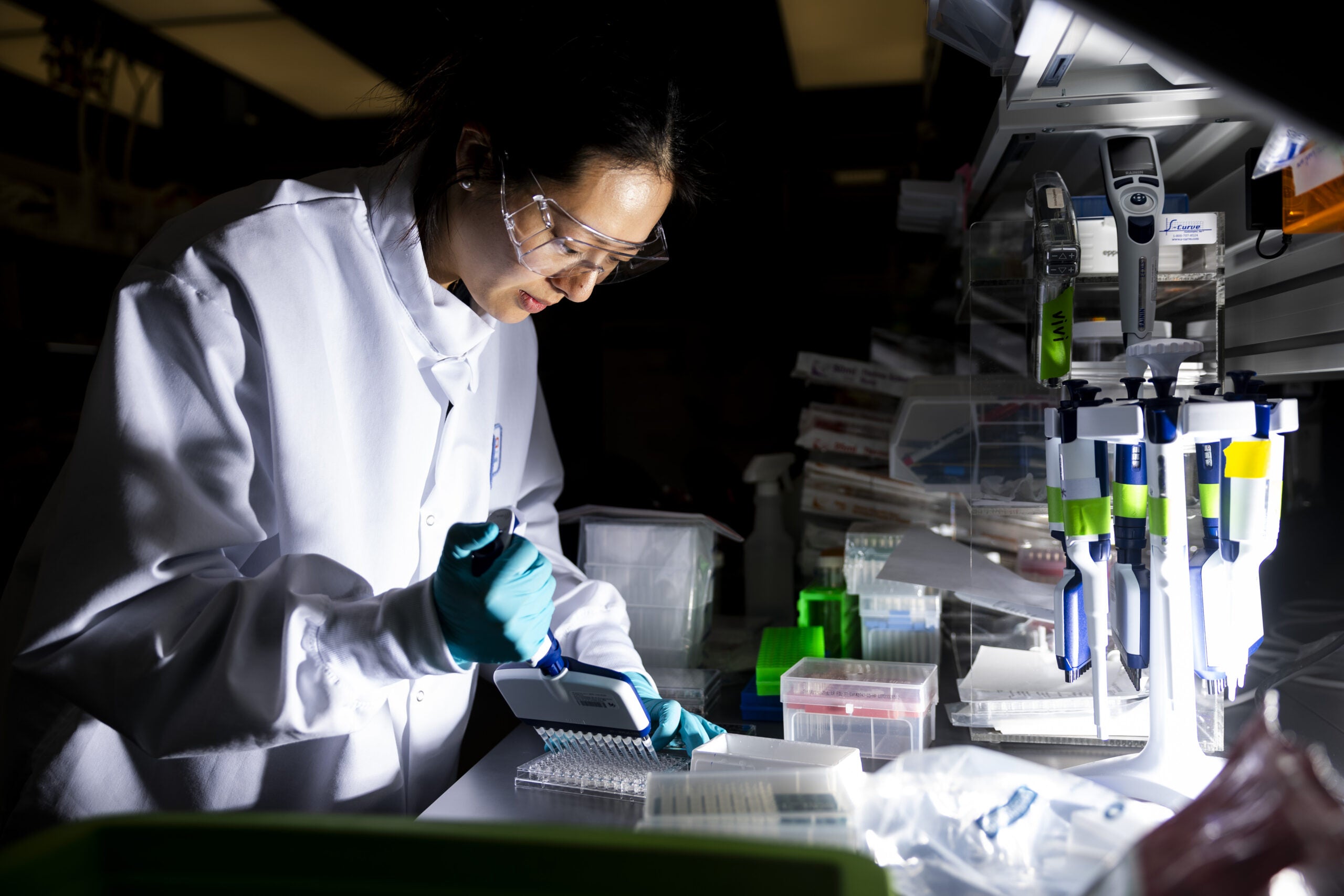 A researcher works in the lab at the Moderna headquarters in Cambridge, Mass.