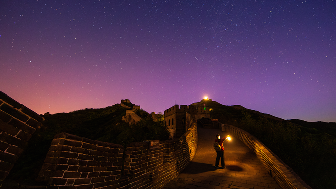 BEIJING, CHINA - MAY 12: The aurora borealis glows in the night sky over the Badaling section of the Great Wall on May 12, 2024 in Beijing, China. Due to the current geomagnetic storm, aurora borealis were observed across China on the night of May 11 and on the early morning of May 12. (Photo by Yang Dong/VCG via Getty Images)