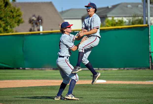 Beckman’s Rex Jarcy (34) and Ethan Rhee (12) celebrate their...