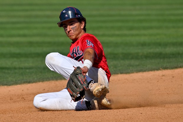 Los Alamitos’ Devin Porch (2) goes after a grounder against...