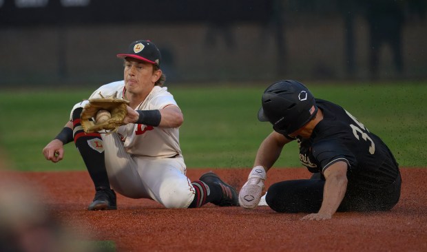 Harvard-Westlake’s Bryce Rainer, right, is safe at second as Orange...