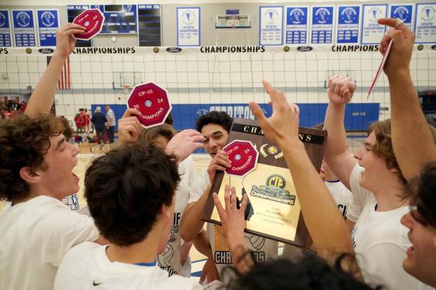 Santa Margarita players celebrate their victory with the championship plaque...