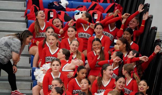 The Redondo cheerleaders support their team during the game between...