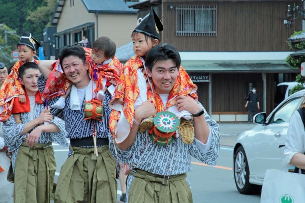 Fathers carry their sons during a festival's spiritual procession in a Japanese village close to the important shrine of Hongu Taisha. (Photo by Norma Meyer)