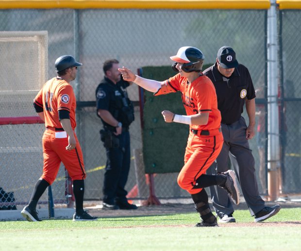 Huntington Beach’s CJ Weinstein heads for home plate after hitting...