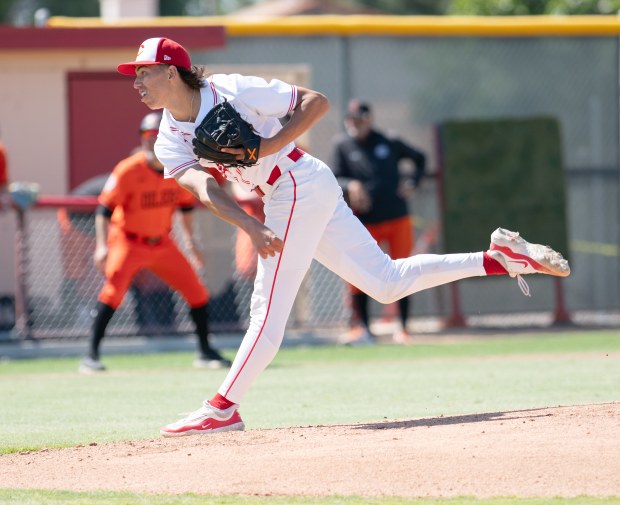 Corona’s starting pitcher Seth Hernandez throws the ball in the...