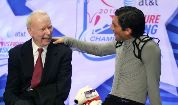 Evan Lysacek puts his hand on the shoulder of his coach, Frank Carroll, as they wait for his scores in the men's free skate at the U.S. Figure Skating Championships on Jan. 17, 2010, in Spokane, Wash. (AP Photo/Jonathan Ferrey, Pool, File)