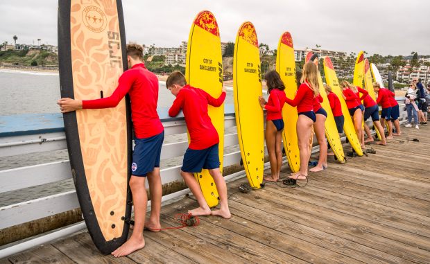 Junior Lifeguards line up jump on the San Clemente Pier...